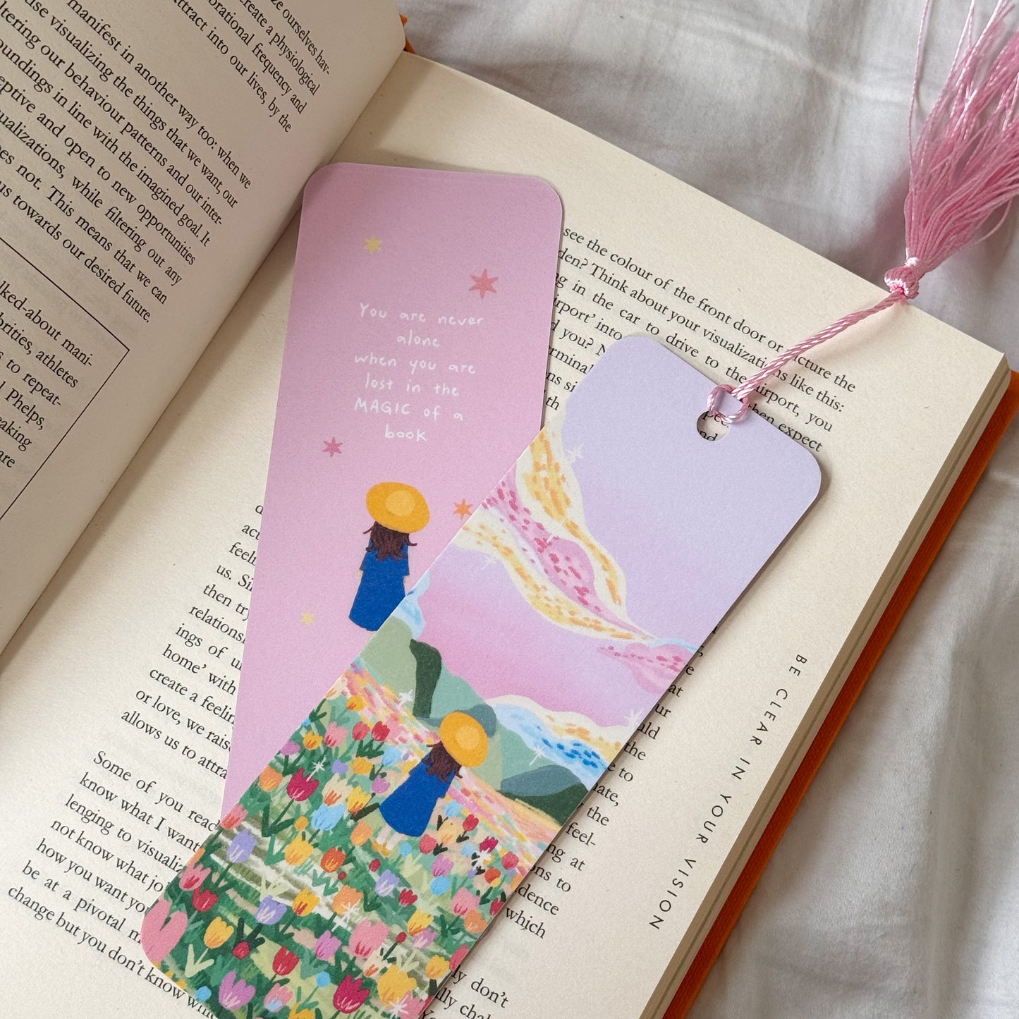 Handmade bookmark titled “Lost in Magic” with a dreamy illustration and the quote “You are never alone when you are lost in magic.” Double-sided design with matte finish and optional tassel.