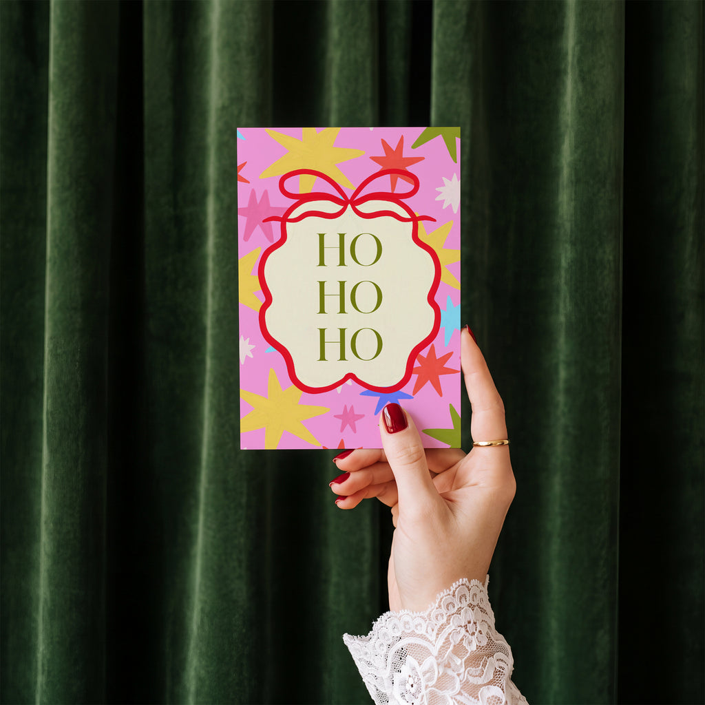 Ho Ho Ho card standing upright showing front cover and envelope edge
