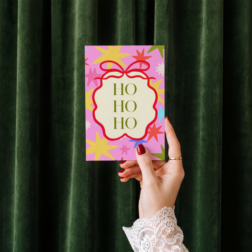 Ho Ho Ho card standing upright showing front cover and envelope edge