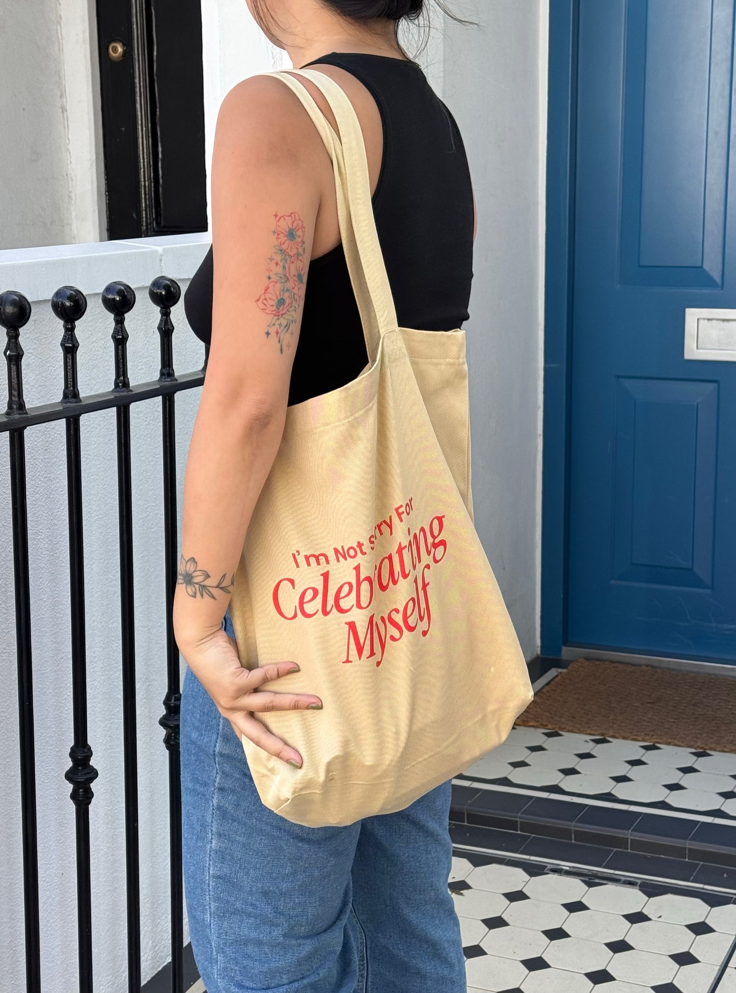 Ziyi Studio organic cotton tote bag featuring “I’m Not Sorry For Celebrating Myself” artwork. Cream-colored, ethically made, printed in Europe, with long straps and open main compartment