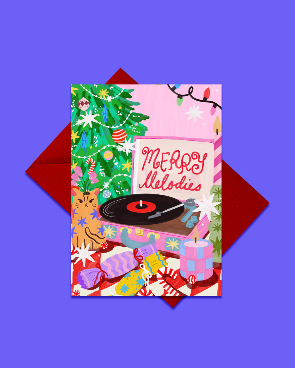A festive illustrated greeting card reading “Merry Melodies,” featuring a Christmas tree, record player, gifts, and holiday lights, shown with a red envelope against a purple background.