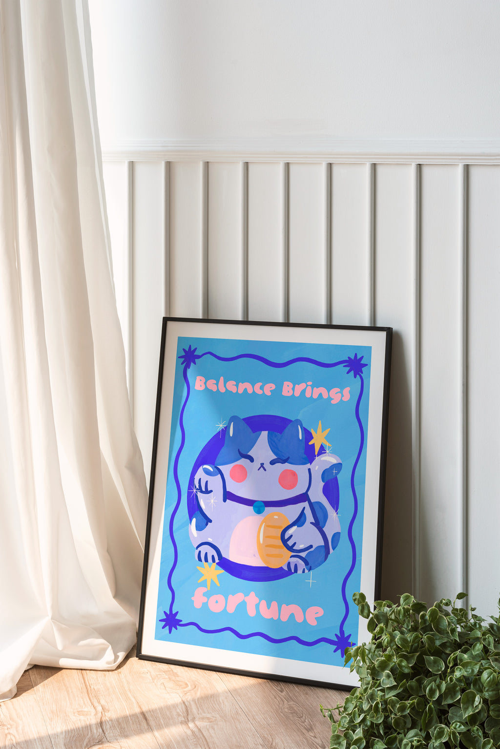 Framed artwork with a cartoon character and text on a white wall.