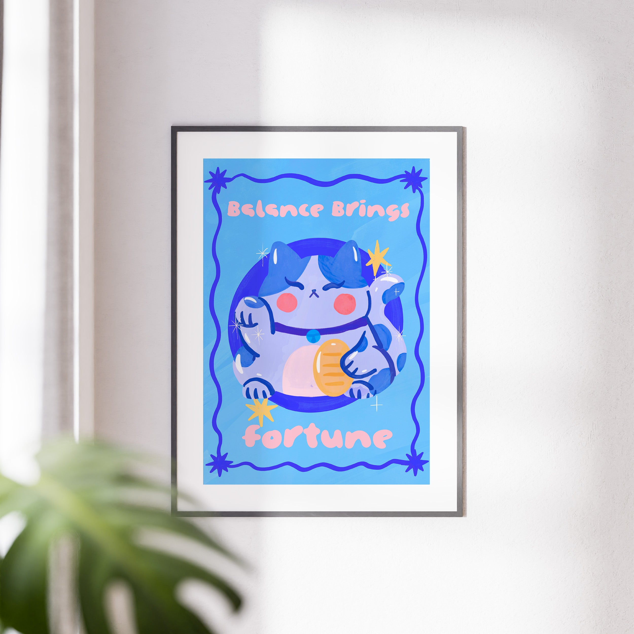 Framed artwork with a cartoon cat and text on a blue background, displayed on a wall.