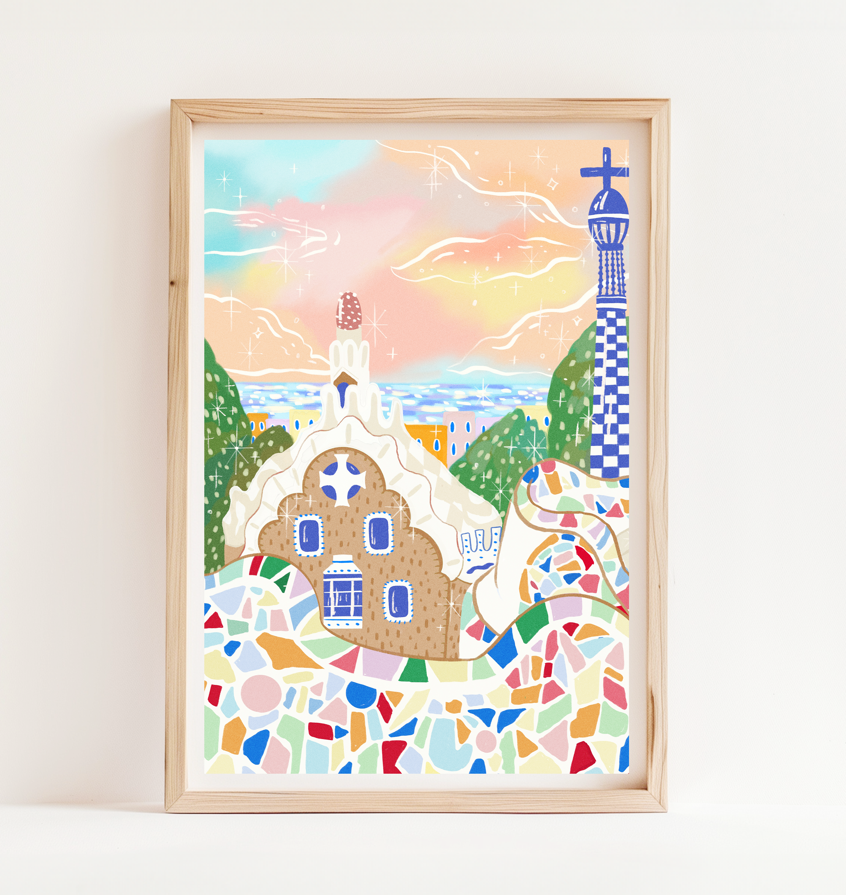 Framed Barcelona art print displayed on interior wall, showcasing colorful Park Güell-inspired mosaic design in a cozy home setting.