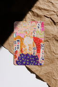 Colorful card with a cat design on a crumpled brown paper background