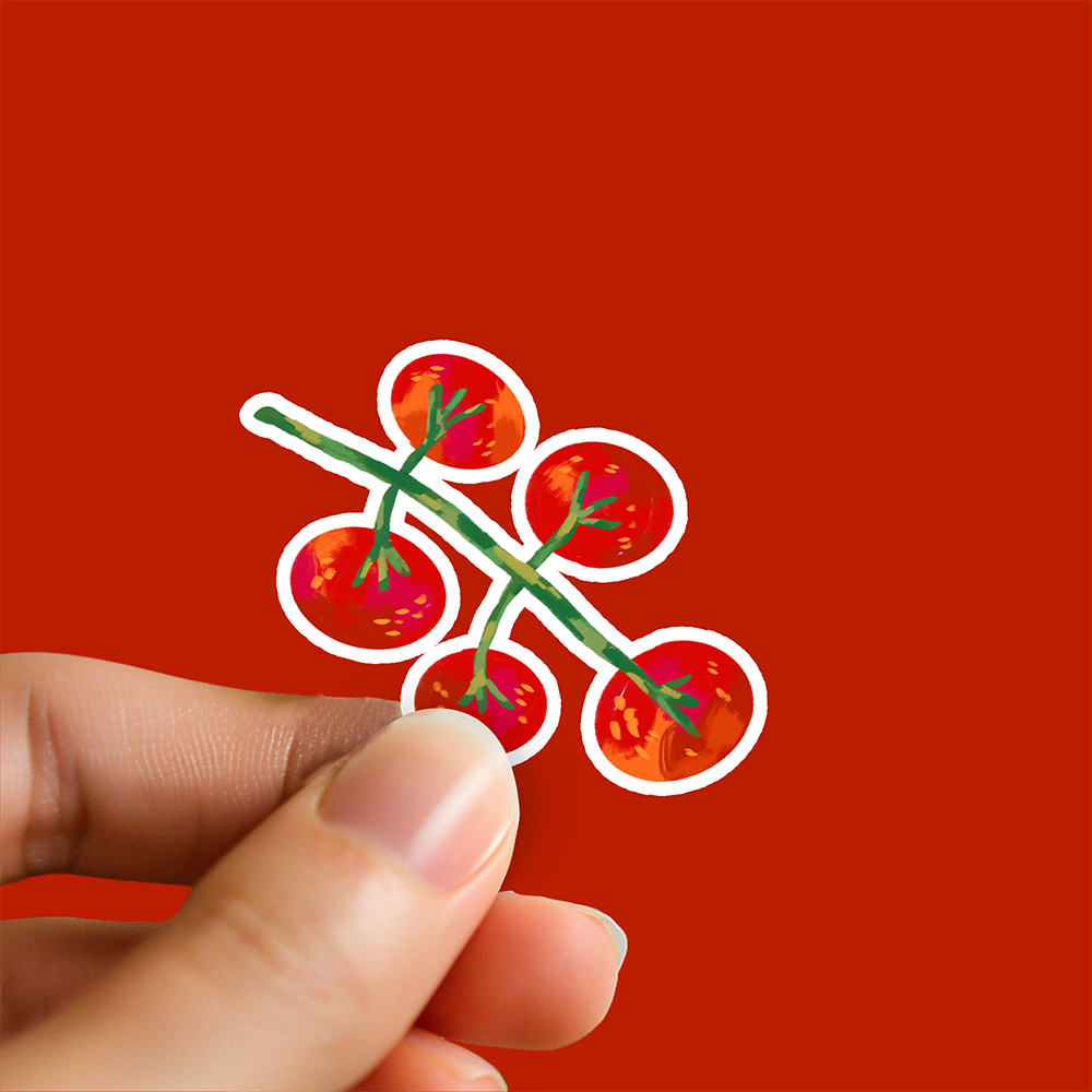 holding a glossy vinyl sticker of a cherry tomato vine, white border, against solid red background. Food-themed sticker by Ziyi Studio.