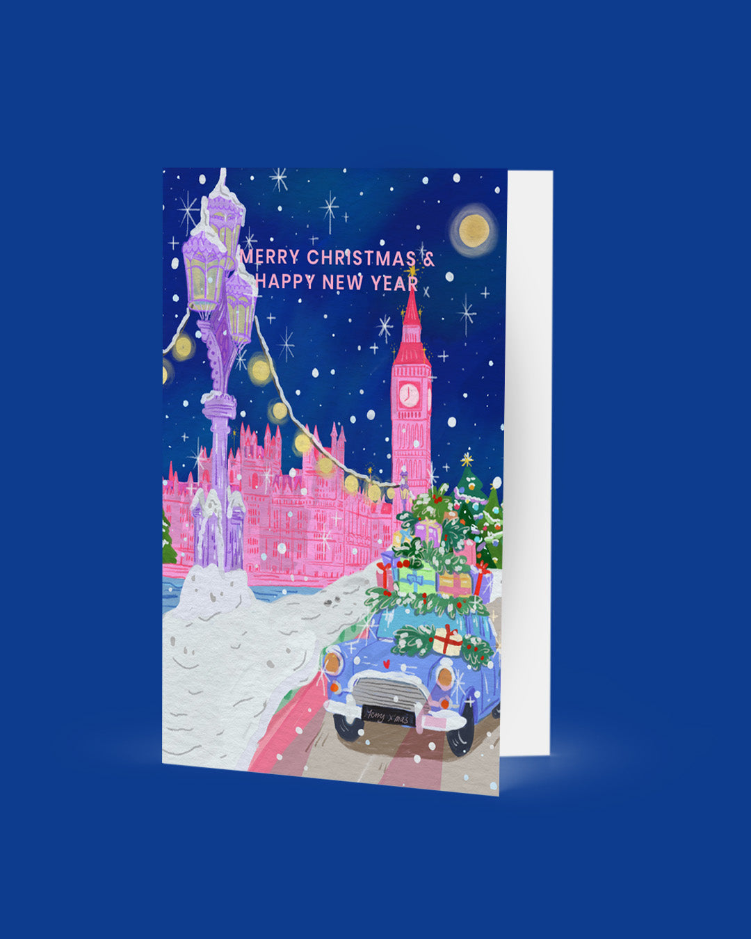 Christmas card with festive design featuring Big Ben and a Christmas tree, on a blue background.