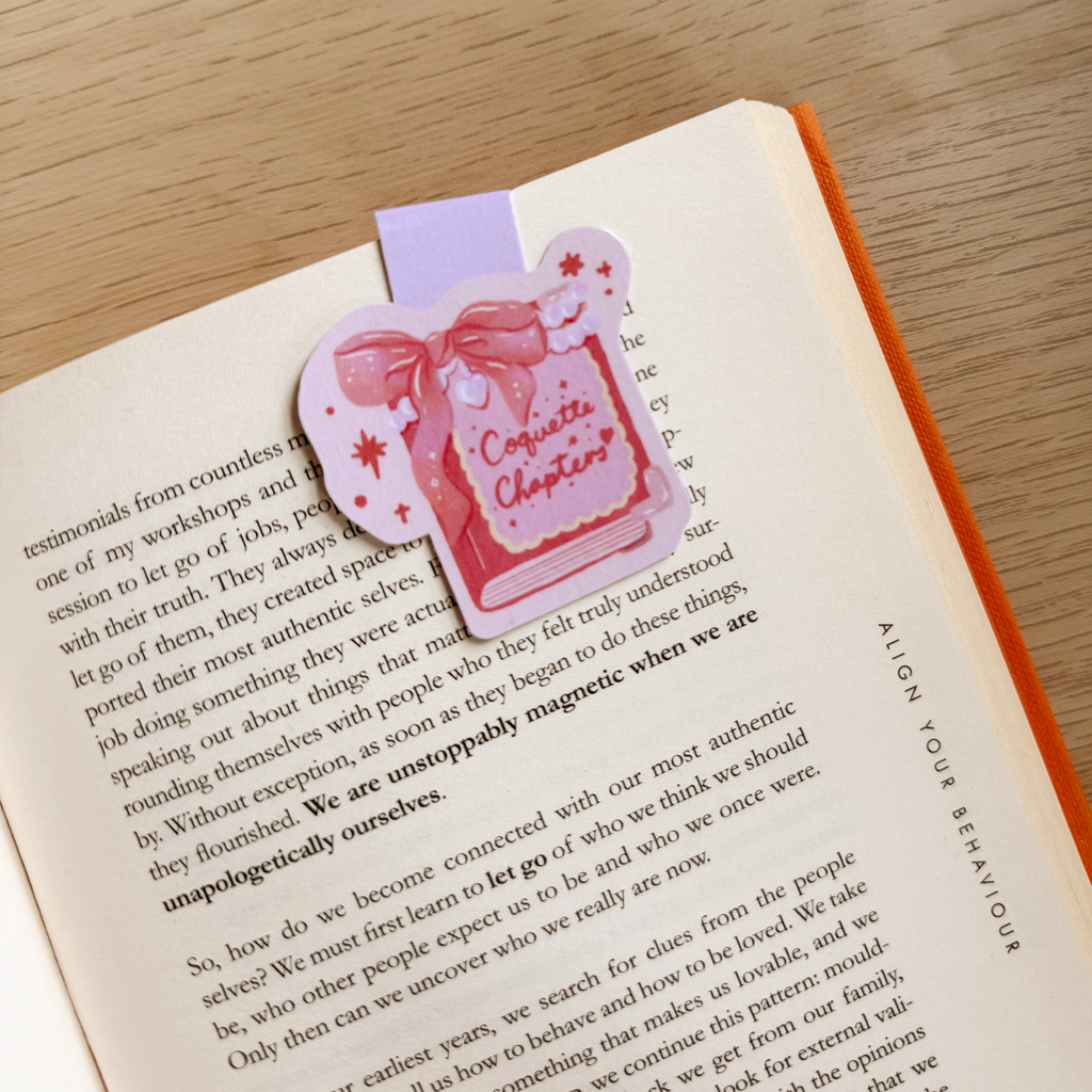 Pink and purple bookmark with a bow design on an open book