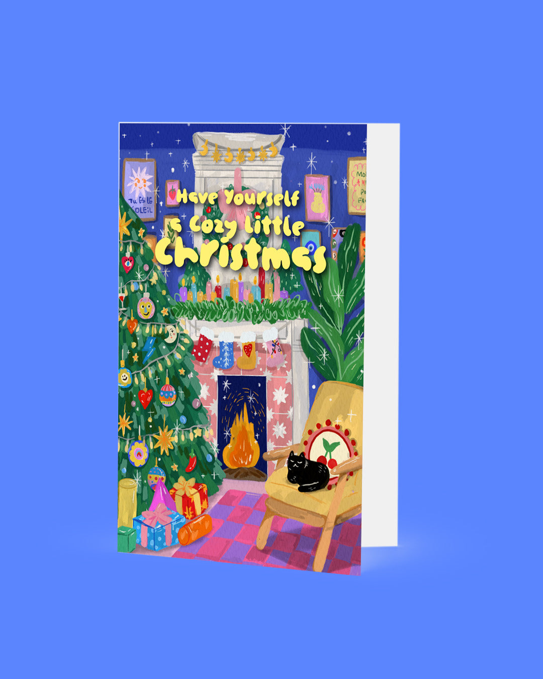 Christmas card with a fireplace, tree, and cat on a blue background