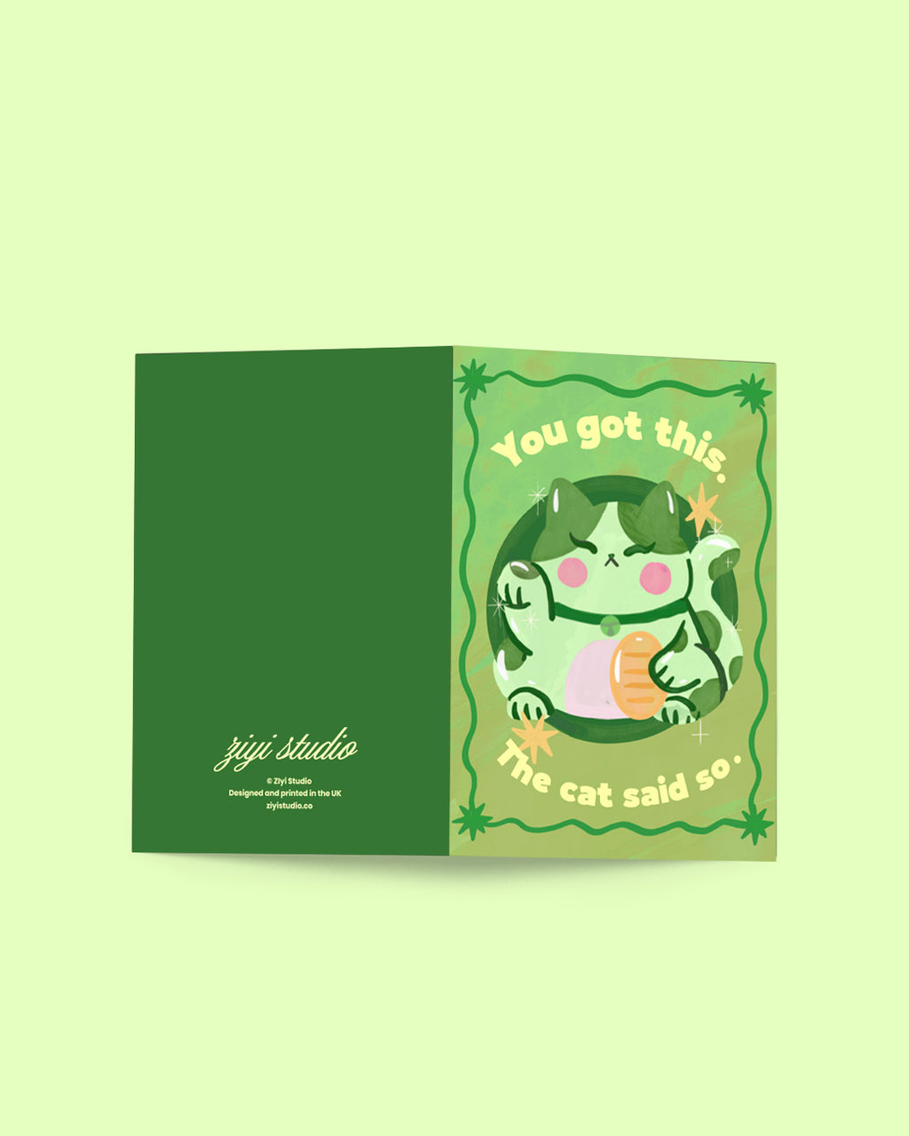 Card with a green border and cartoon cat illustration on a light green background