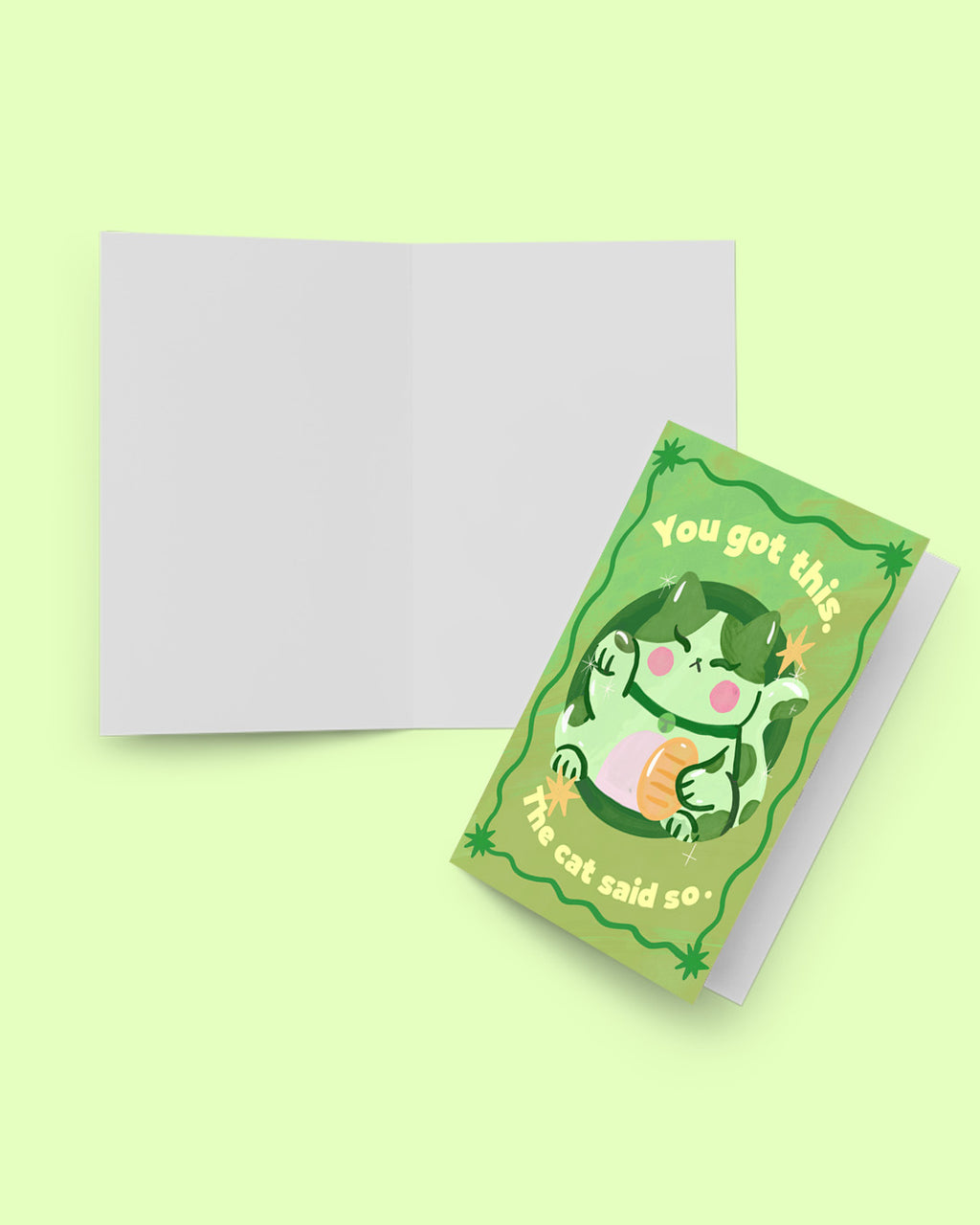 Green greeting card with a cat illustration and text, placed on a light green background.