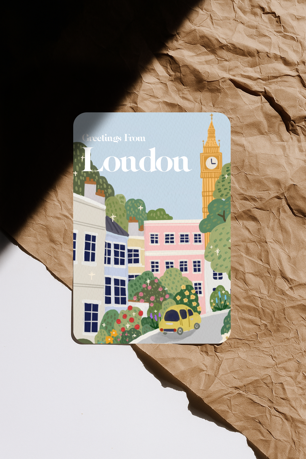 Greetings From London postcard featuring Big Ben and colourful townhouses illustration.