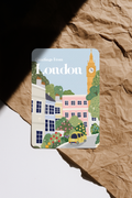 Greetings From London postcard featuring Big Ben and colourful townhouses illustration.