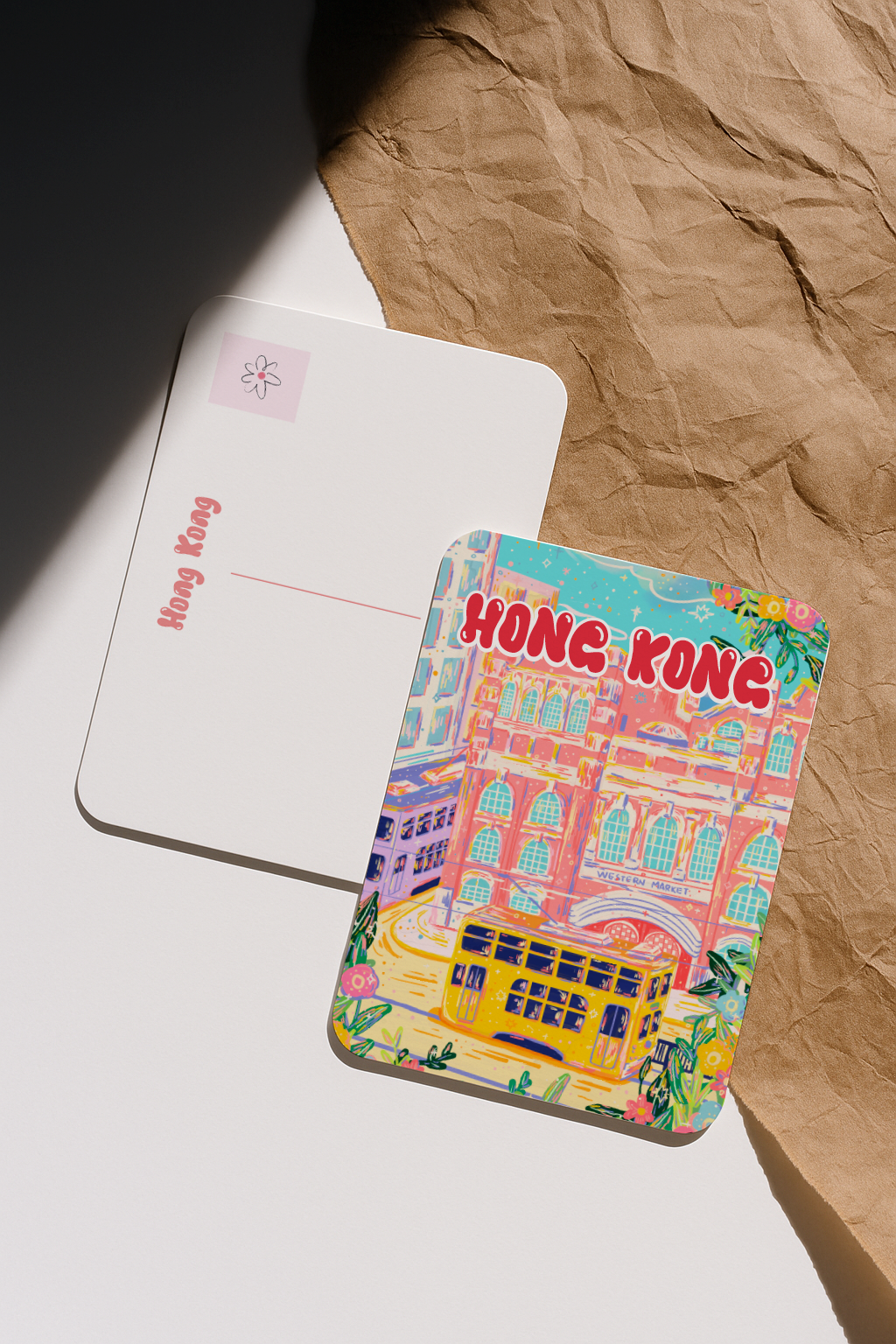 Back and front view of Western Market Hong Kong postcard on textured paper background.