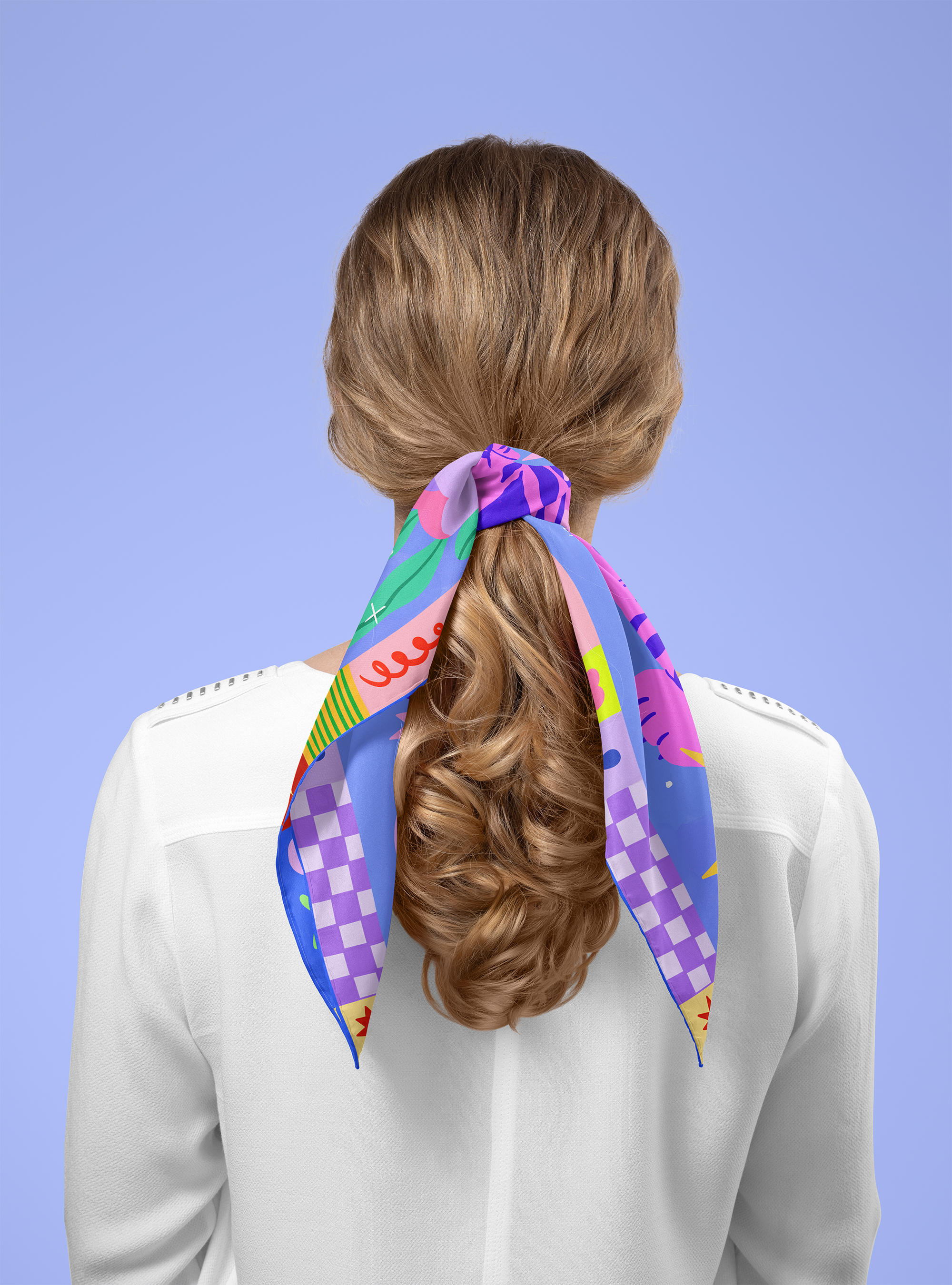 Person wearing a colorful scarf tied around their head against a blue background