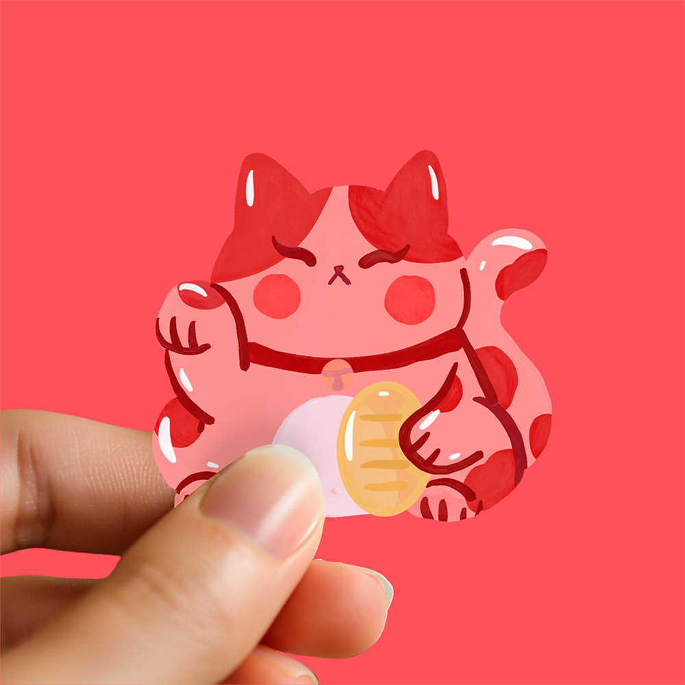 Red beckoning cat waterproof sticker held in hand, glossy finish Japanese lucky cat Maneki-neko