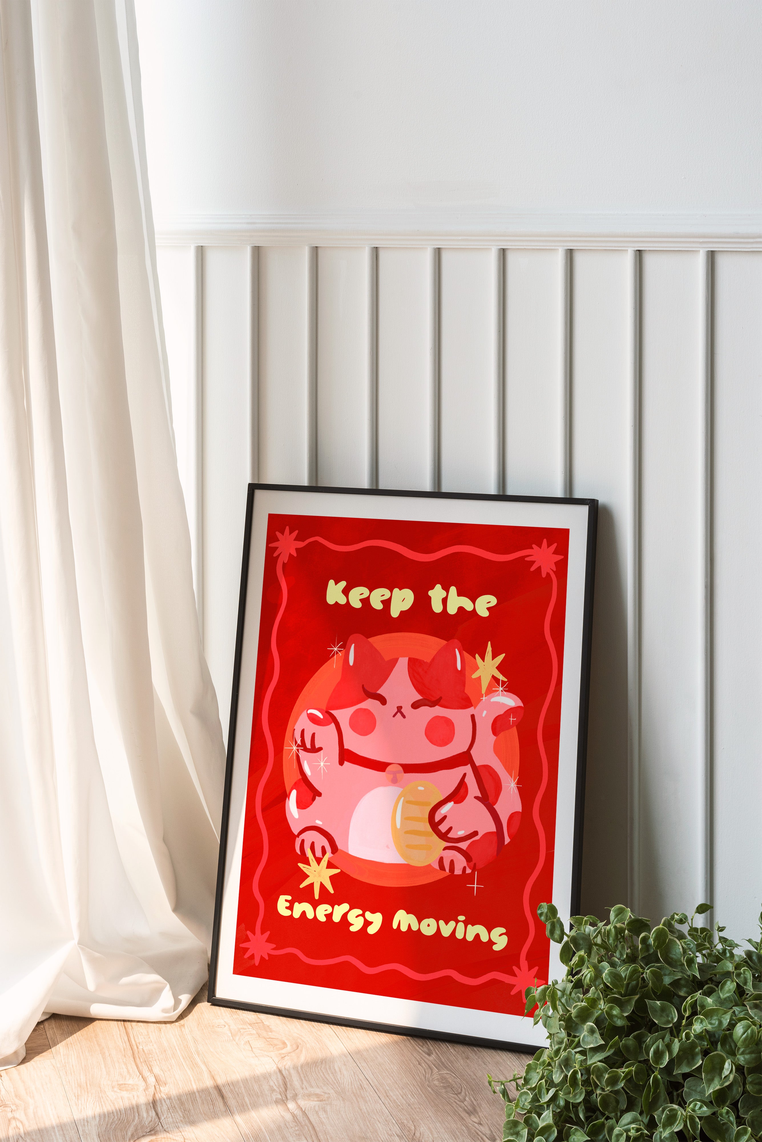 Framed artwork with a red background and cartoon character on a white wall.