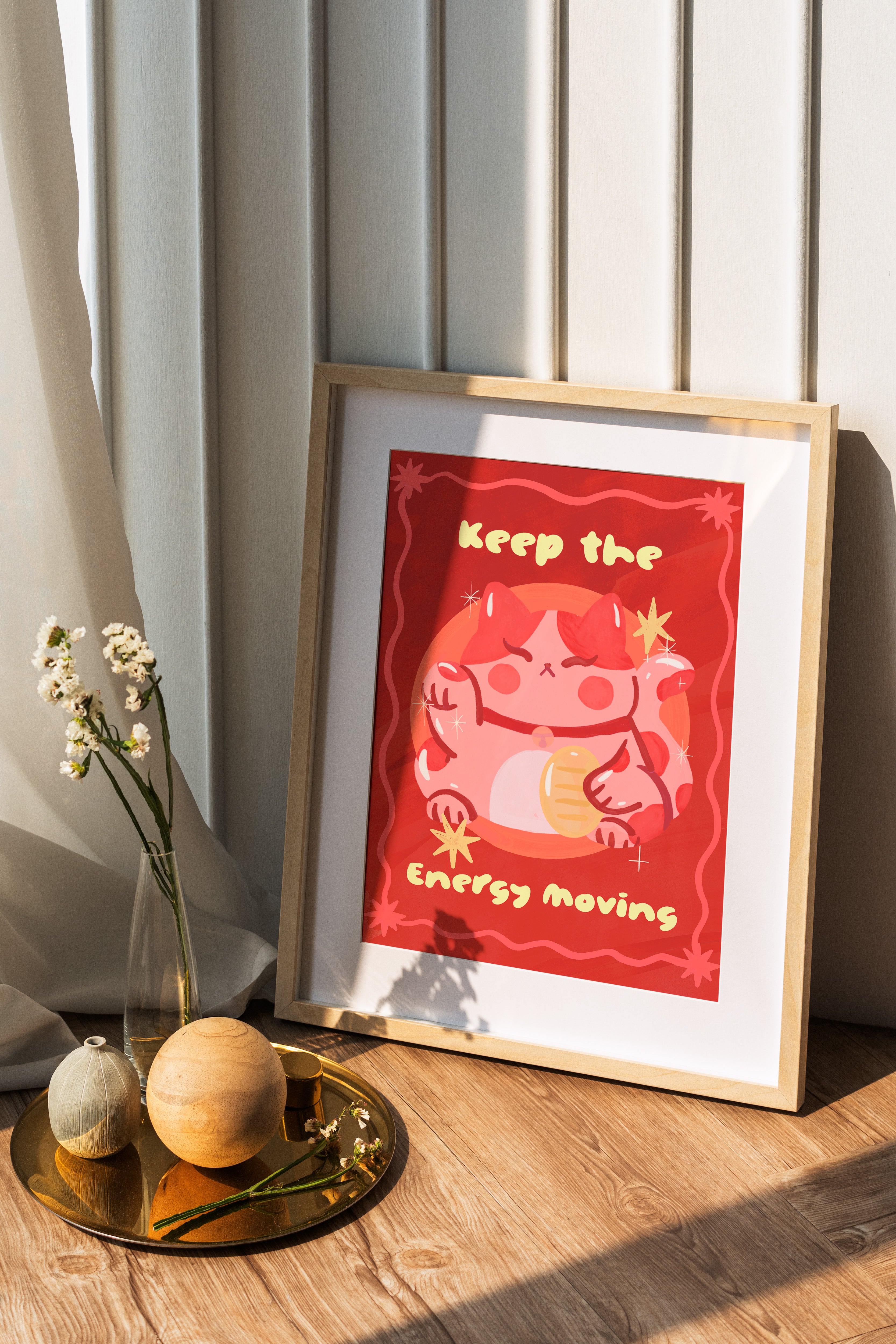 Framed artwork with motivational quote on a wooden surface with decorative items.