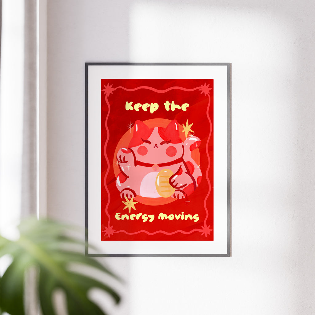 Framed artwork with a red background and cartoon character, featuring text 'Keep the Energy Moving'.
