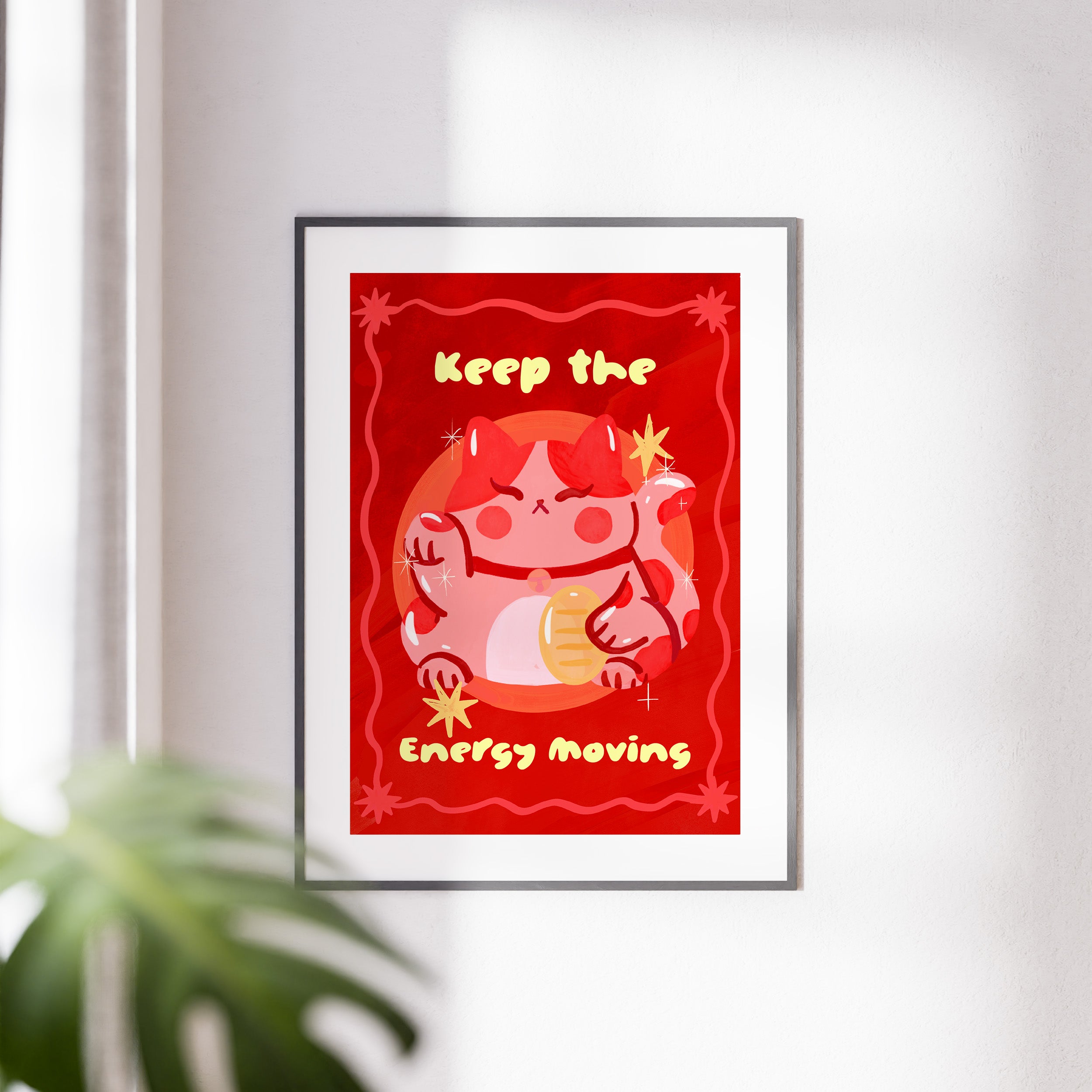 Framed artwork with a red background and cartoon character, featuring text 'Keep the Energy Moving'.