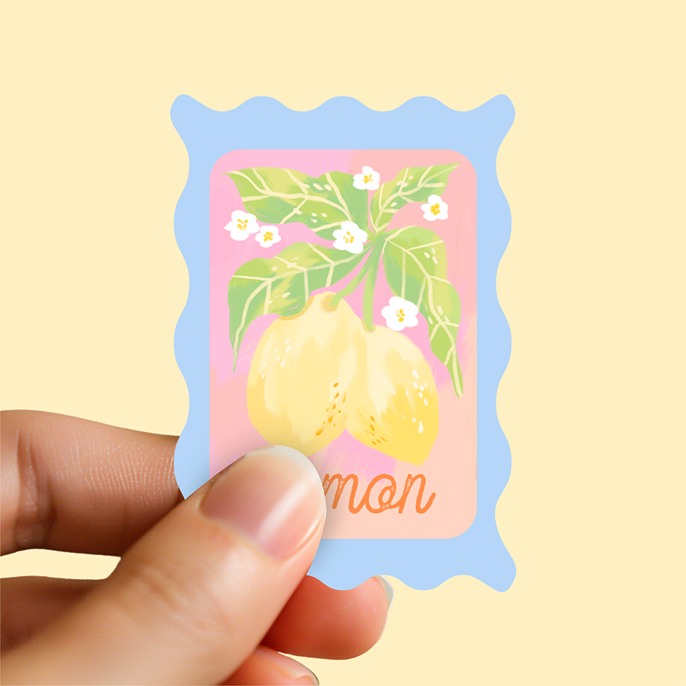 Mini glossy vinyl sticker shaped like a postage stamp with hand-drawn lemons and blossoms. Pastel summer design by Ziyi Studio.