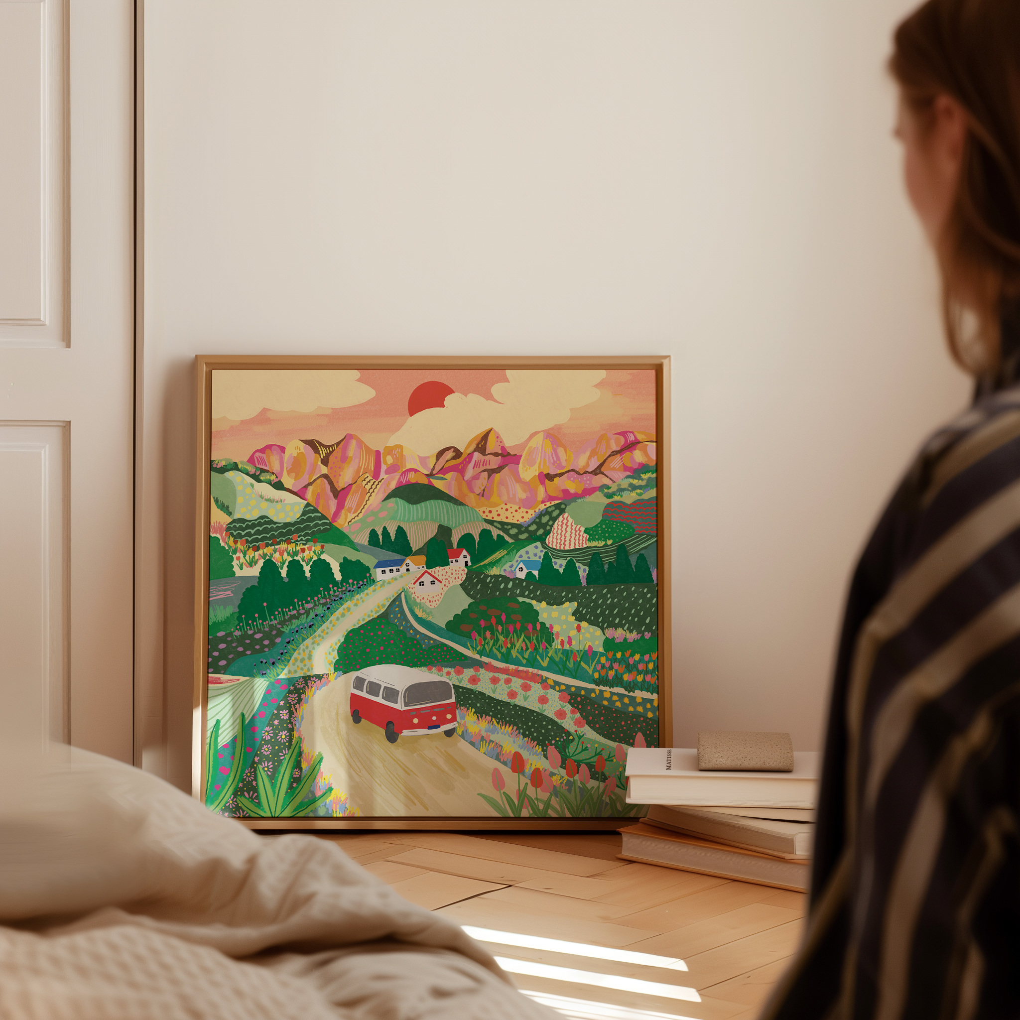 Let's Go On A Trip travel art print displayed on bedroom floor with books, colourful campervan landscape by Ziyi StudioLet's Go On A Trip travel art print displayed on bedroom floor with books, colourful campervan landscape by Ziyi Studio