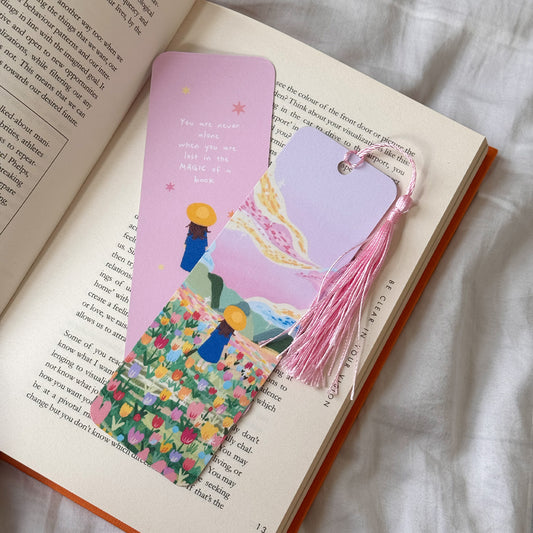 Handmade bookmark titled “Lost in Magic” with a dreamy illustration and the quote “You are never alone when you are lost in magic.” Double-sided design with matte finish and optional tassel.