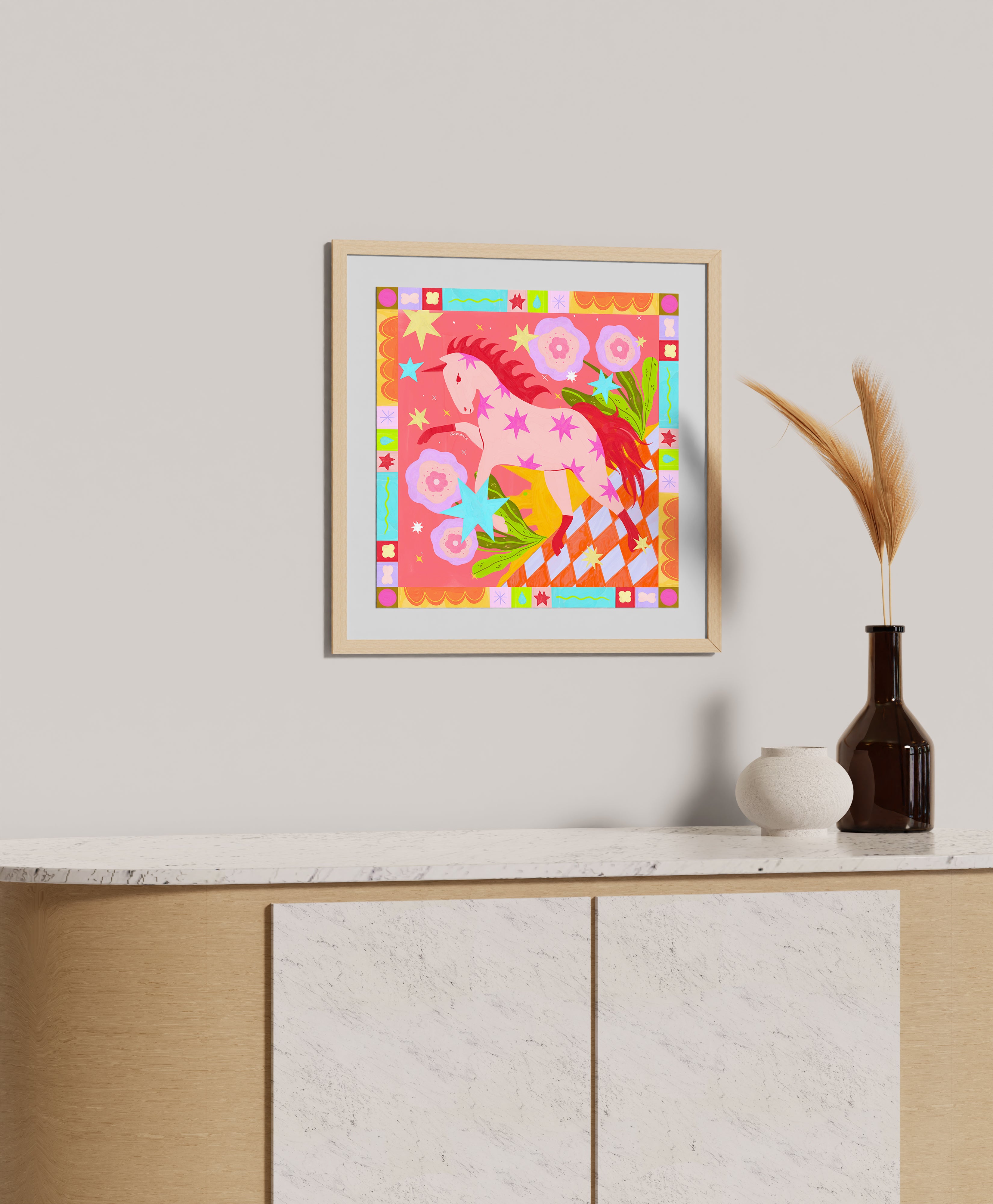 Vibrant folk art print of pink horse with decorative pattern border in white frame, maximalist wall decor