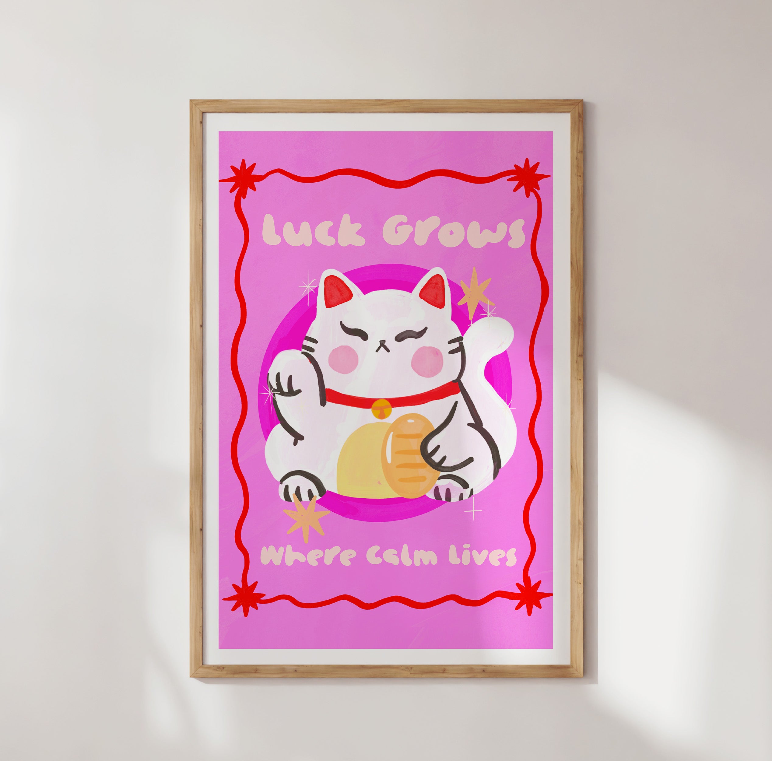 Framed artwork with a cartoon cat and text on a pink background