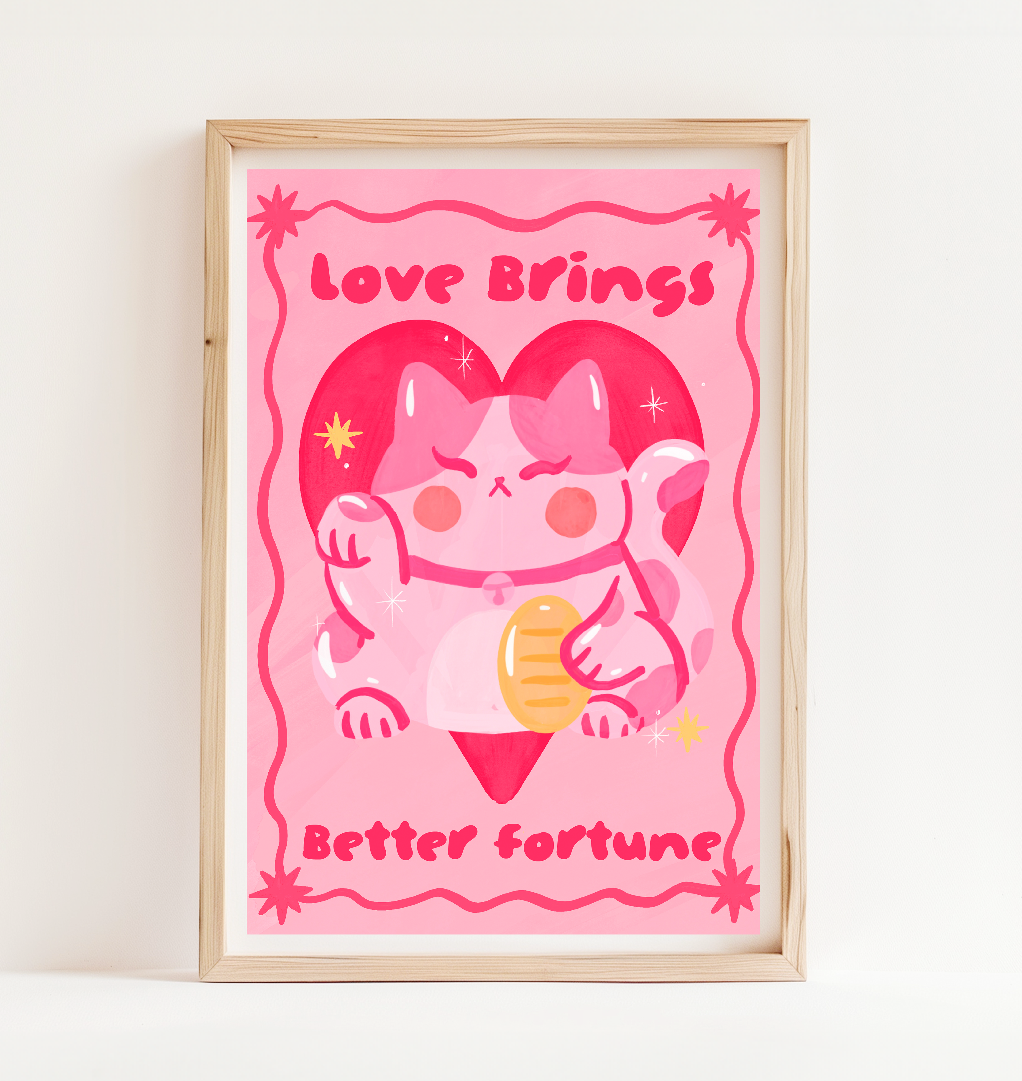 Framed artwork with a cartoon cat holding a heart and text 'Love Brings Better Fortune' on a pink background.