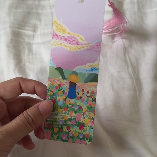 Handmade bookmark titled “Lost in Magic” with a dreamy illustration and the quote “You are never alone when you are lost in magic.” Double-sided design with matte finish and optional tassel.