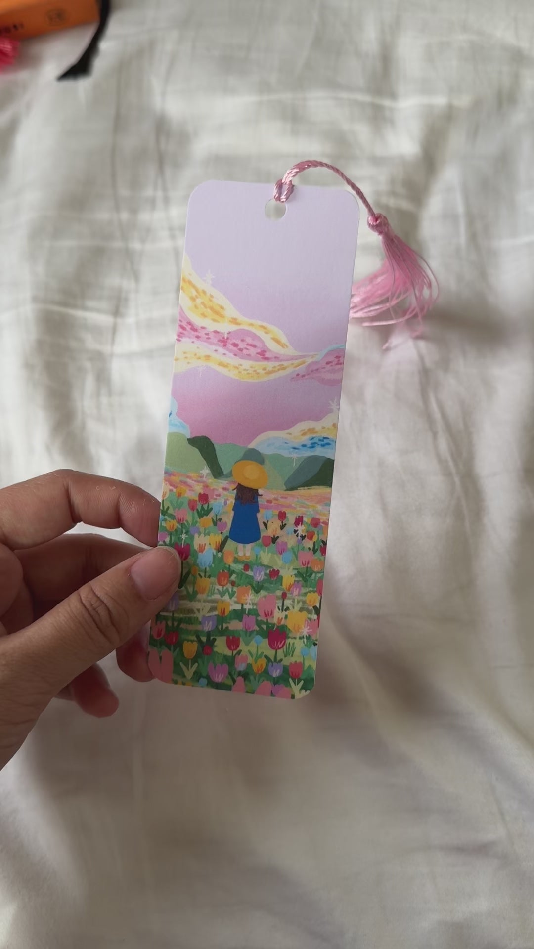 Handmade bookmark titled “Lost in Magic” with a dreamy illustration and the quote “You are never alone when you are lost in magic.” Double-sided design with matte finish and optional tassel.