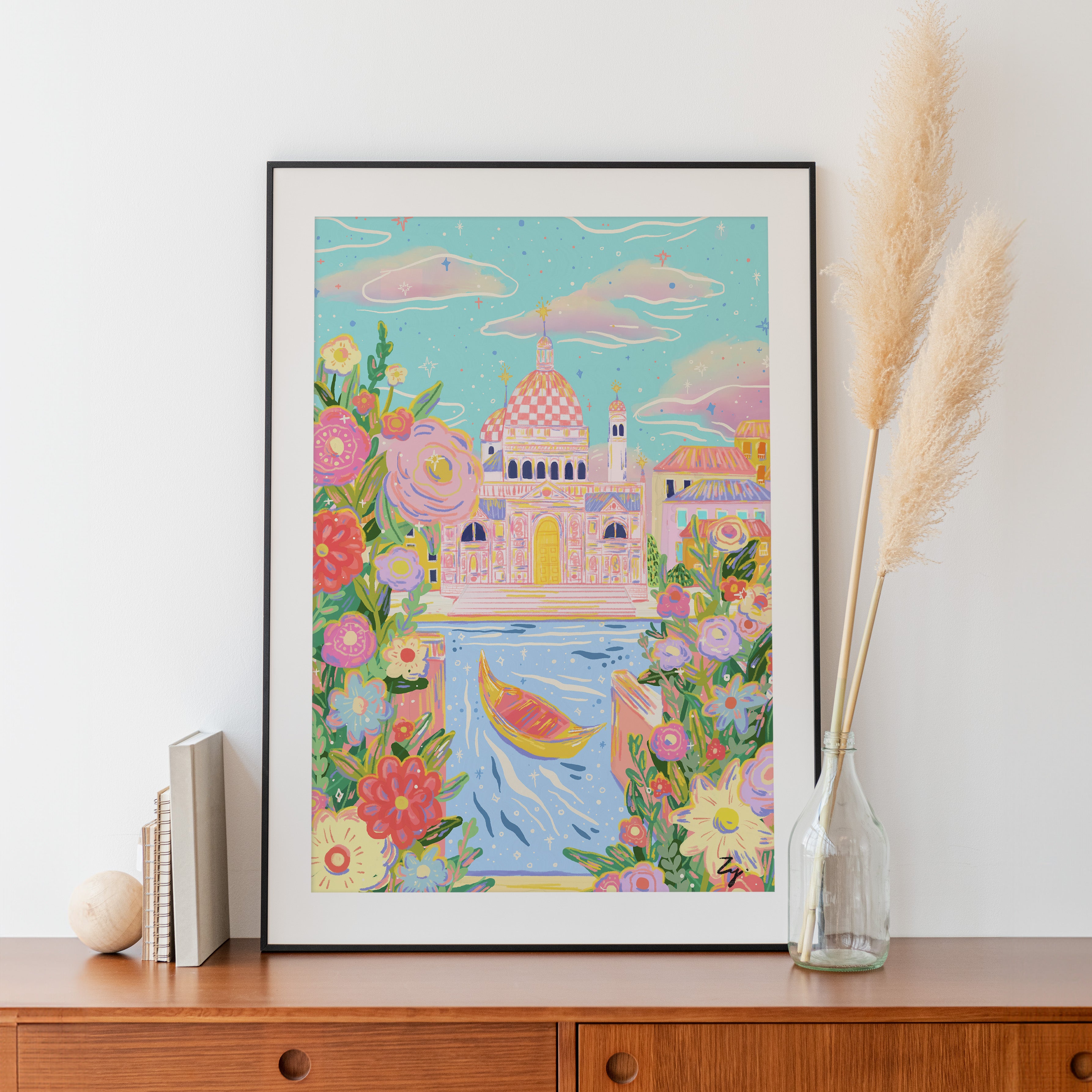 Venice Daydream travel print displayed on wooden cabinet with pampas grass and books